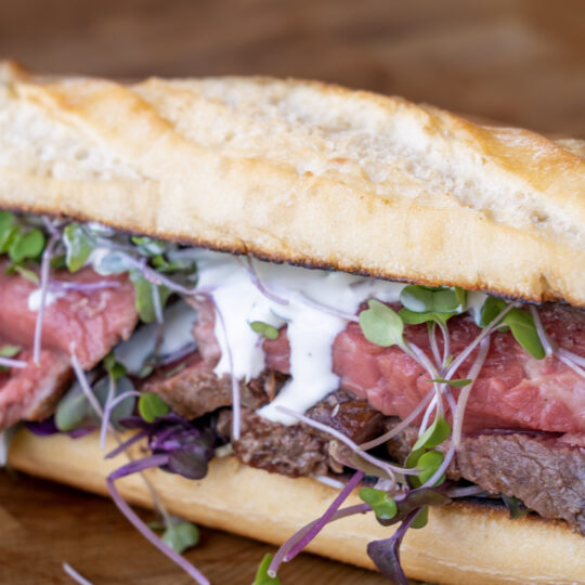 Close up shot of the steak sandwich with horseradish sauce